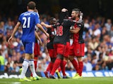 Bafetibis Gomis and Jordi Amat of Swansea City celebrate as John Terry of Chelsea scores an own goal for their first goal during the Barclays Premier League match between Chelsea and Swansea City at Stamford Bridge on September 13, 2014