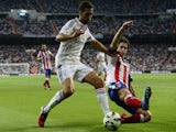 Real Madrid's defender Alvaro Arbeloa (L) vies with Atletico Madrid's Portuguese midfielder Tiago during the Spanish league football match on September 13, 2014