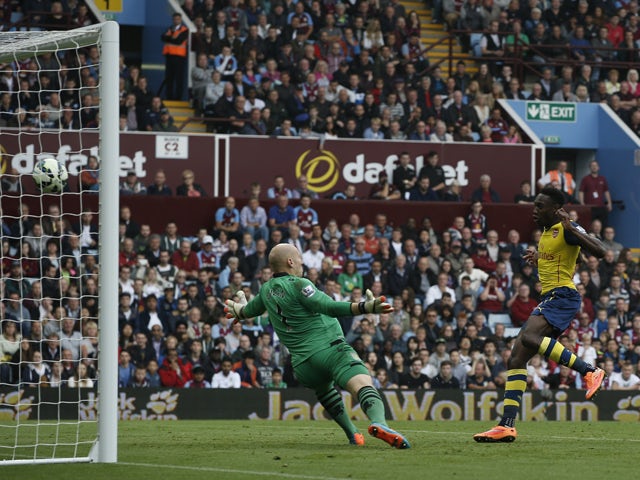 Arsenal's English striker Danny Welbeck shoots to score their second goal during the English Premier League football match between Aston Villa and Arsenal at Villa Park in Birmingham, central England on September 20, 2014