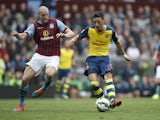 Arsenal's German midfielder Mesut Ozil shoots to score the opening goal during the English Premier League football match between Aston Villa and Arsenal at Villa Park in Birmingham, central England on September 20, 2014