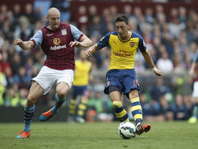 Arsenal's German midfielder Mesut Ozil shoots to score the opening goal during the English Premier League football match between Aston Villa and Arsenal at Villa Park in Birmingham, central England on September 20, 2014