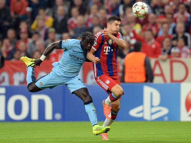 Bayern Munich's Polish striker Robert Lewandowski and Manchester City's French defender Bacary Sagna challenge for the ball during the first leg UEFA Champions League Group E football match Borussia FC Bayern Munchen v Manchester City in Munich, Germany o