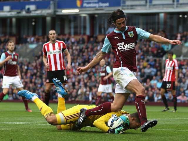 Vito Mannone of Sunderland dives to make a save at the feet of George Boyd of Burnley during the Barclays Premier League match between Burnley and Sunderland at Turf Moor on September 20, 2014