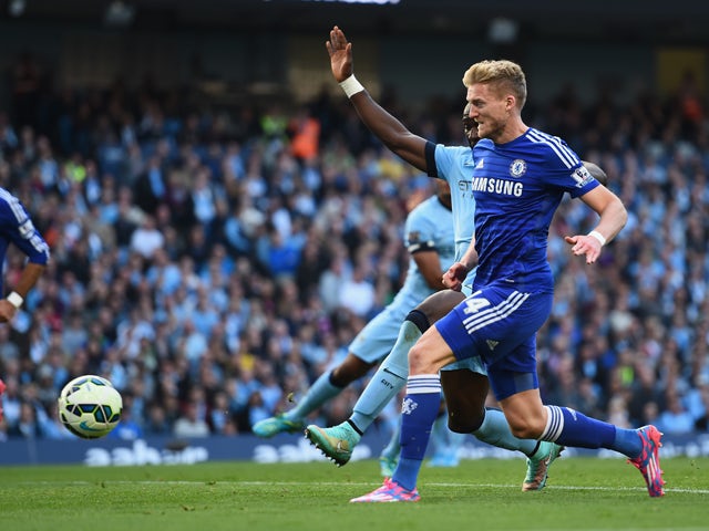Andre Schurrle of Chelsea scores the first goal during the Barclays Premier League match between Manchester City and Chelsea at the Etihad Stadium on September 21, 2014