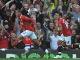 Manchester United's English defender Chris Smalling (L) celebrates after scoring the opening goal of the English Premier League football match against Chelsea on September 18, 2011