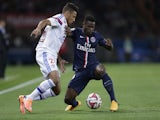 Lyon's French midfielder Corentin Tolisso (L) vies with Paris Saint-Germain's French defender Serge Aurier during the French L1 football match on September 21, 2014