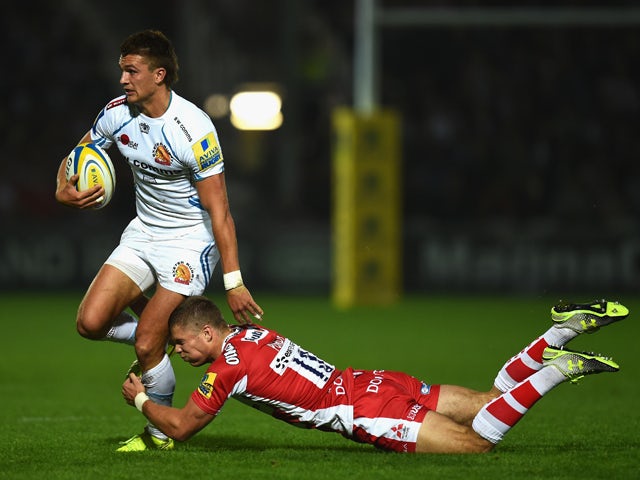 Chiefs player Henry Slade breaks the tackle of Gloucester centre Henry Purdey during the Aviva Premiership match between Gloucester Rugby and Exeter Chiefs at Kingsholm Stadium on September 19, 2014