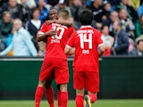 Hakim Ziyech of Twente is congratulated by team mates Kamohelo Mokotjo and Ryo Miyaichi after scoring a goal during the Dutch Eredivisie match between Heracles Almelo and FC Twente at Polman Stadion on September 21, 2014