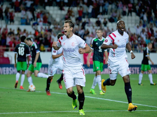 Grzegorz Krychowiak (L) of Sevilla FC celebrates scoring their opening goal with teammate Stephane Mbia Etoundi (R) during the UEFA Europa League group G match against Feyenoord on September 18, 2014