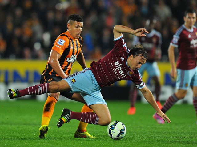 Hull player Jake Livermore challenges Mark Noble of West Ham during the Barclays Premier League match between Hull City and West Ham United at KC Stadium on September 15, 2014