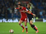 Cardiff player John Brayford (l) is challenged by Adam Clayton of Middlesbrough during the Sky Bet Championship match on September 16, 2014