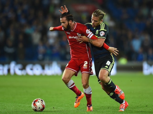 Cardiff player John Brayford (l) is challenged by Adam Clayton of Middlesbrough during the Sky Bet Championship match on September 16, 2014