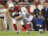 Running back Jonathan Dwyer #20 of the Arizona Cardinals rushes the football against outside linebacker Jarret Johnson #96 of the San Diego Chargers during the NFL game at the University of Phoenix Stadium on September 8, 2014