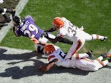 Justin Forsett #29 of the Baltimore Ravens gets dragged down by Tashaun Gipson #39 and Christian Kirksey #58 of the Cleveland Browns on September 21, 2014