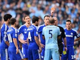 Referee Mike Dean shows a red card to Pablo Zabaleta of Manchester City during the Barclays Premier League match between Manchester City and Chelsea at the Etihad Stadium on September 21, 2014