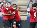 Manchester United's Dutch striker Robin van Persie celebrates scoring the opening goal with teammates during the English Premier League football match between Leicester City and Manchester United at the King Power Stadium in Leicester on September 21, 201