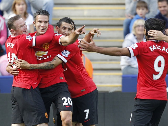 Manchester United's Dutch striker Robin van Persie celebrates scoring the opening goal with teammates during the English Premier League football match between Leicester City and Manchester United at the King Power Stadium in Leicester on September 21, 201