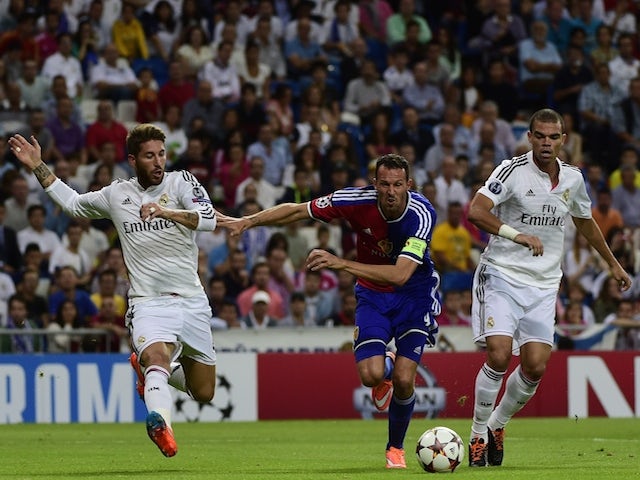 Basel's forward Marco Streller (C) vies with Real Madrid's defender Sergio Ramos (L) and Real Madrid's Portuguese defender Pepe (R) during the UEFA Champions League match on September 16, 2014