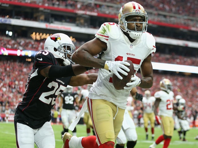 Wide receiver Michael Crabtree #15 of the San Francisco 49ers catches a touchdown pass over Cornerback Jerraud Powers #25 of the Arizona Cardinals on September 21, 2014