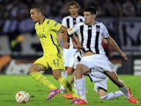 Nabil Bentaleb (L) of Tottenham Hotspur is challenged by Petar Grbic (R) of Partizan during the UEFA Europa League match between Partizan and Tottenham Hotspur on September 18, 2014