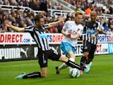 Stephen Quinn of Hull City is tackled by Paul Dummett of Newcastle United during the Barclays Premier League match between Newcastle United and Hull City at St James' Park on September 20, 2014