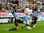 Stephen Quinn of Hull City is tackled by Paul Dummett of Newcastle United during the Barclays Premier League match between Newcastle United and Hull City at St James' Park on September 20, 2014