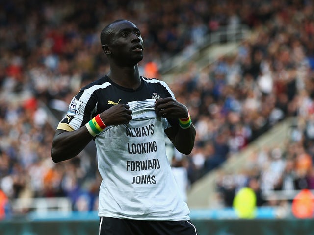 Papiss Cisse of Newcastle United shows his siupport to team mate Jonas Gutierrez after scoring his second goal during the Barclays Premier League match between Newcastle United and Hull City at St James' Park on September 20, 2014