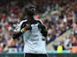 Papiss Cisse of Newcastle United shows his siupport to team mate Jonas Gutierrez after scoring his second goal during the Barclays Premier League match between Newcastle United and Hull City at St James' Park on September 20, 2014
