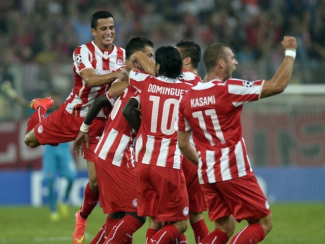 Olympiakos players celebrate after scoring during the Champions League group A fooball match at the Karaiskaki stadium in Piraeus near Athens on September 16, 2014