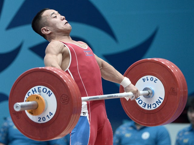 Gold medalist Om Yun-Chol of North Korea attempts a lift in the men's 56kg weightlifting event during the 2014 Asian Games in Incheon on September 20, 2014