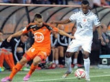 Lorient's French Portuguese defender Raphael Guerreiro (L) vies with Reims' Cape Verdean forward Odair Fortes during the French L1 football match between Lorient and Reims on September 20, 2014