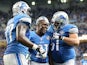 Reggie Bush #21 of the Detroit Lions celebrates with teammates Cornelius Lucas #77 and Dominic Raiola #51 after scoring on a 21 yard touchdown against the Green Bay Packers on September 21, 2014