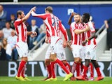 Mame Biram Diouf of Stoke City celebrates scoring the opening goal with team mates during the Barclays Premier League match between Queens Park Rangers and Stoke City at Loftus Road on September 20, 2014