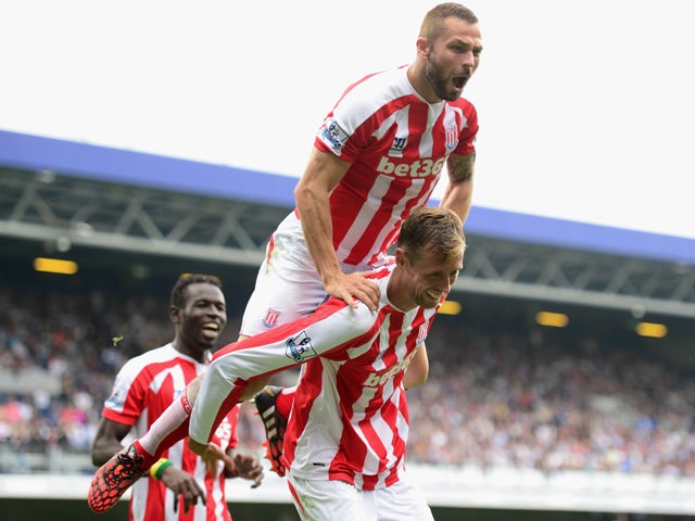 Peter Crouch of Stoke City celebrates his goal with Phil Bardsley of Stoke City during the Barclays Premier League match between Queens Park Rangers and Stoke City at Loftus Road on September 20, 2014