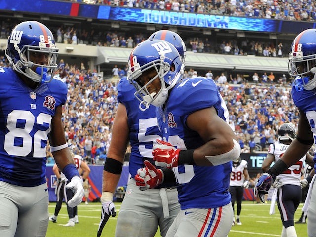 Victor Cruz #80 of the New York Giants celebrates his touchdown with a dance against the Houston Texans in the second quarter at MetLife Stadium on September 21, 2014