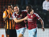 Enner Valencia of West Ham United celebrates with team mate Stewart Downing of West Ham United as he scores their first goal during Barclays Premier League match between Hull City and West Ham United at KC Stadium on September 15, 2014