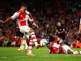 Alex Oxlade-Chamberlain of Arsenal scores his team's first goal during the Barclays Premier League match between Arsenal and Tottenham Hotspur on September 27, 2014
