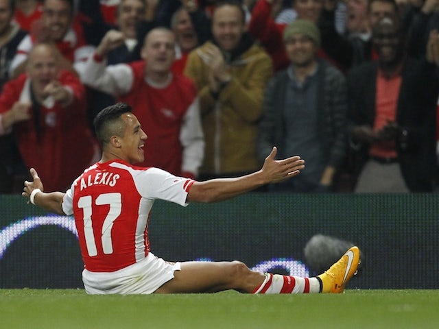 Arsenal's Chilean striker Alexis Sanchez celebrates scoring the opening goal from a freekick during the English League Cup third round football match against Southampton on September 23, 2014