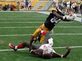 Antonio Brown #84 of the Pittsburgh Steelers catches his second touchdown of the game in front of Alterraun Verner #21 of the Tampa Bay Buccaneers on September 28, 2014