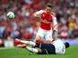 Mesut Ozil of Arsenal in action against Danny Rose of Spurs during the Barclays Premier League match between Arsenal and Tottenham Hotspur at Emirates Stadium on September 27, 2014