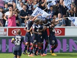 Bordeaux' s Thomas Toure is congratulated by teammates after scoring the second goal during the French L1 footbal match Bordeaux vs Rennes on September 28, 2014
