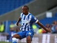 Chris O'Grady of Brighton looks to get past Jack Deaman of Cheltenham during the Capital One Cup First Round match between Brighton & Hove Albion and Cheltenham Town at The Amex Stadium on August 12, 2014