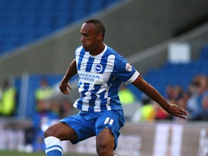 Chris O'Grady of Brighton looks to get past Jack Deaman of Cheltenham during the Capital One Cup First Round match between Brighton & Hove Albion and Cheltenham Town at The Amex Stadium on August 12, 2014