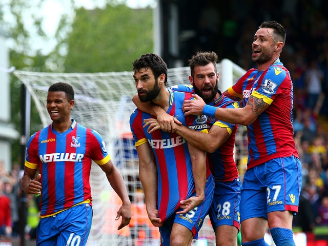 Mile Jedinak of Crystal Palace celebrates with team-mates after scoring his team's second goal during the Barclays Premier League match between Crystal Palace and Leicester City at Selhurst Park on September 27, 2014