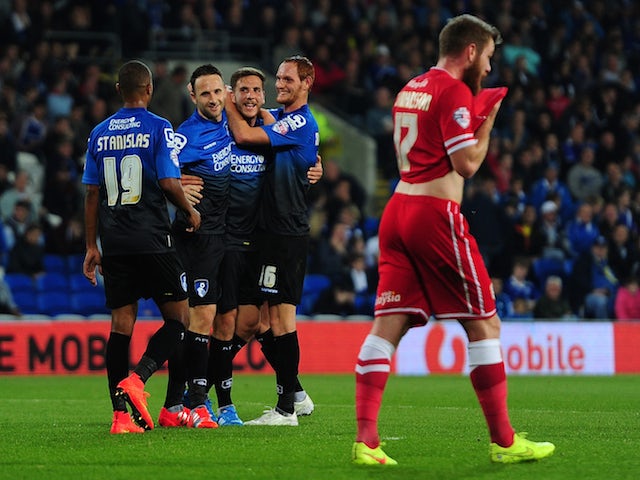Dan Gosling of Bournemouth (C) celebrates with his team mates after scoring his side's third goal during the Capital One Cup third round match against Cardiff City on September 23, 2014