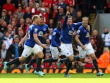Phil Jagielka of Everton celebrates with teammates after scoring a late goal to level the scores at 1-1 during the Barclays Premier League match between Liverpool and Everton at Anfield on September 27, 2014