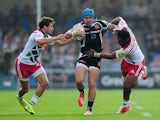 Jack Nowell of Exeter Chiefs is tackled by Ollie Lindsay-Hague and Asaeli Tikoirotuma of Harlequins during the Aviva Premiership match between Exeter Chiefs and Harlequins at Sandy Park on September 28, 2014