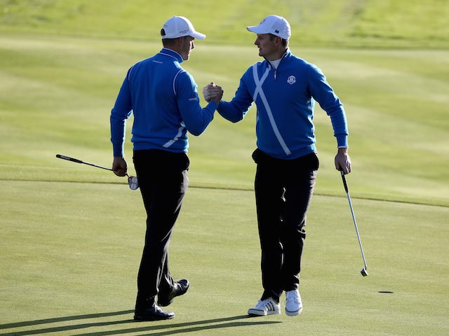 Justin Rose (R) of Europe celebrates his birdie with Henrik Stenson on the 4th hole during the Morning Fourballs of the 2014 Ryder Cup on the PGA Centenary course at Gleneagles on September 26, 2014