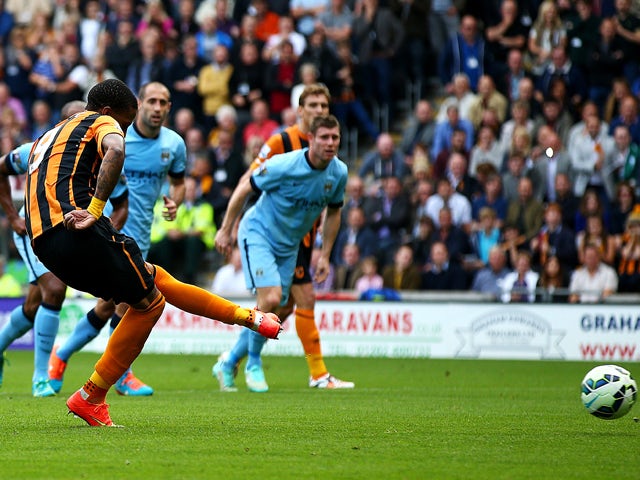 Abel Hernandez of Hull City scores from the penalty spot during the Barclays Premier League match between Hull City and Manchester City at KC Stadium on September 27, 2014