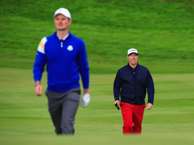 ustin Rose (L) of Europe and Hunter Mahan of the United States walk on the 1st hole during the Singles Matches of the 2014 Ryder Cup on the PGA Centenary course at Gleneagles on September 28, 2014